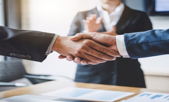 Finishing up a meeting, Business shaking hands after discussing good deal of Trading to sign agreement and become a partner, contract for both companies, Successful businessman handshake.